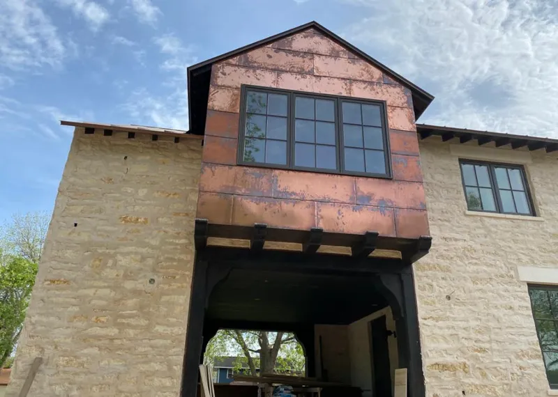 Copper metal panel facade on a stone building for Skylight Installation in Dentsville