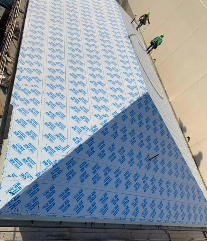 Professional roofers installing underlayment on a metal roof in Dentsville